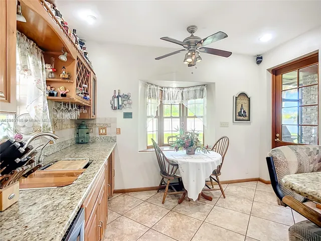a view of a kitchen with a sink cabinets and wooden floor