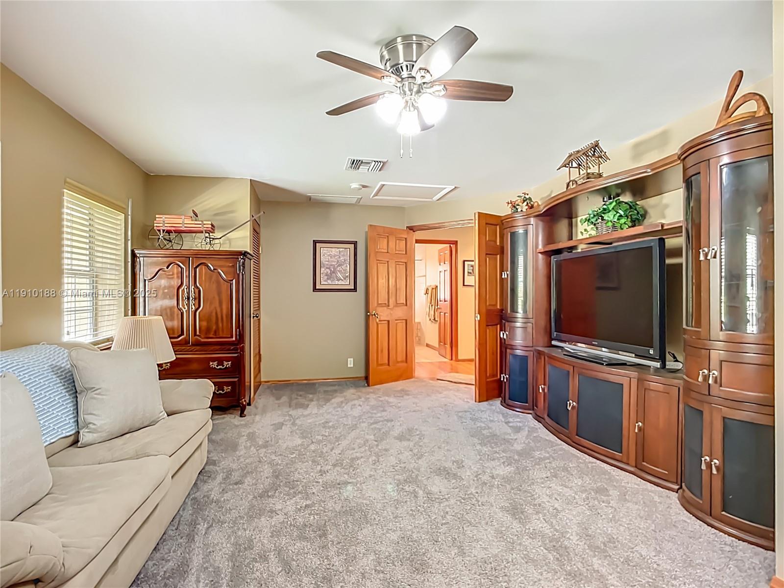 3144 Shell Lane LaBelle, FL 33935 - Photo 32 of 69 a living room with furniture and a flat screen tv