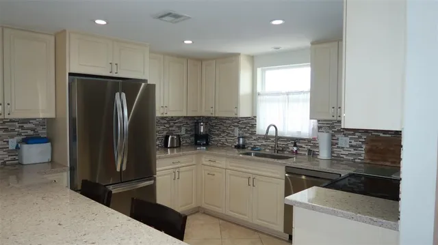 a kitchen with a refrigerator and a sink