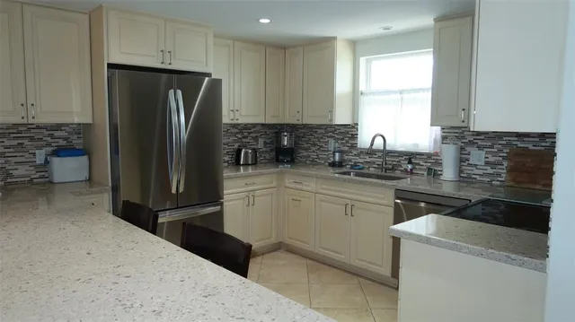a kitchen with a refrigerator stove and sink