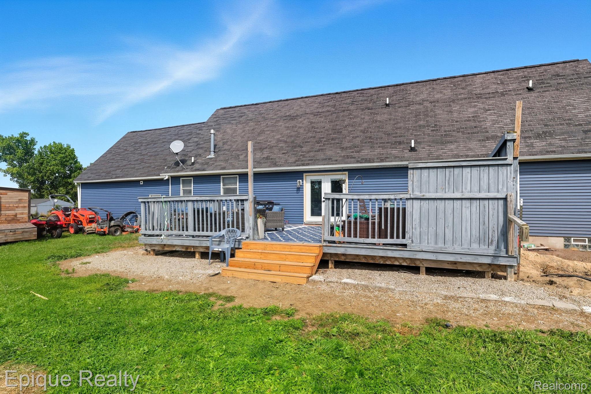 13265 Tibbets Road Memphis, MI 48041 - Photo 31 of 48 Rear view of house featuring a deck and a shingled roof