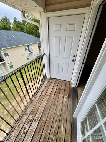 a view of balcony with wooden floor
