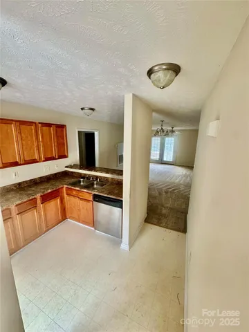 a large kitchen with stainless steel appliances a large counter top