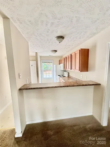 a view of a bedroom with wooden floor and cabinet