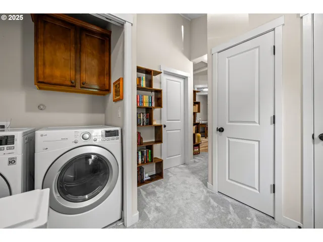 a living room with closet and a washer dryer