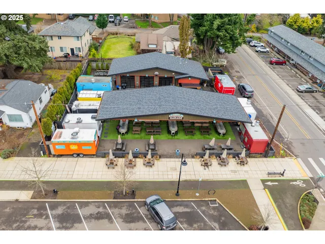 an aerial view of multiple houses with a swimming pool