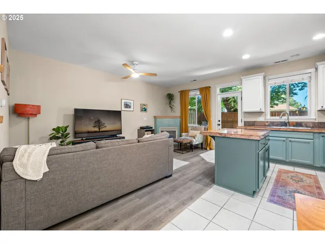 a living room with furniture a flat screen tv and a large window