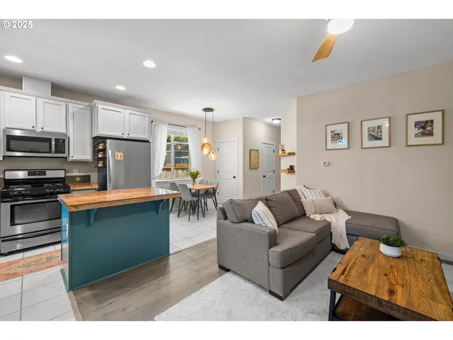 a living room with furniture and kitchen view