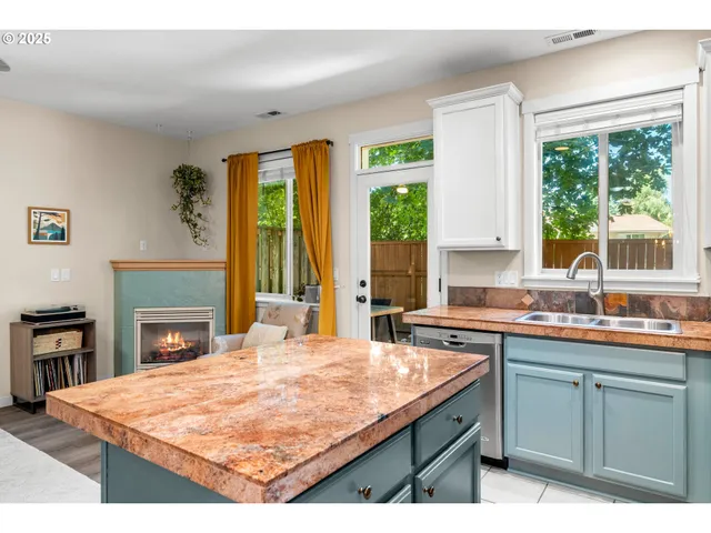 a kitchen with a stove a sink a counter space and a refrigerator