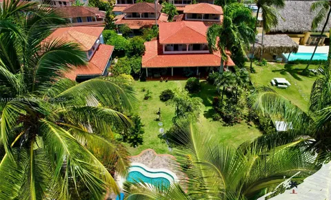 an aerial view of multi story residential apartment building with yard and parking space