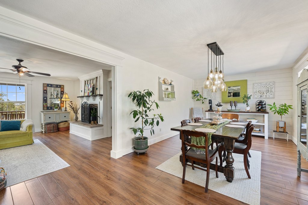 290 Sunset Ridge Dripping Springs, TX 78620 - Photo 36 of 36 An inviting open floorplan seamlessly connects living and dining spaces, highlighted by rich hardwood flooring and elegant crown molding.