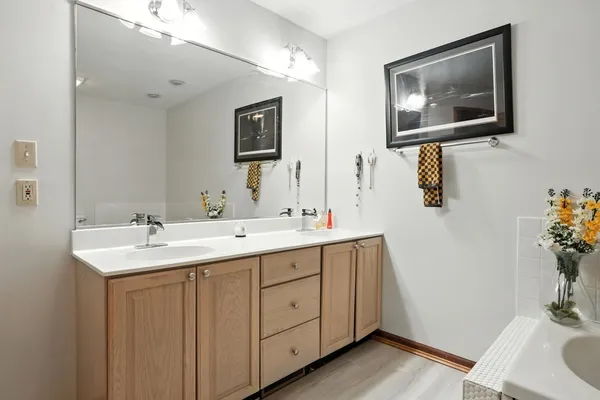 a bathroom with 2 sink and a mirror