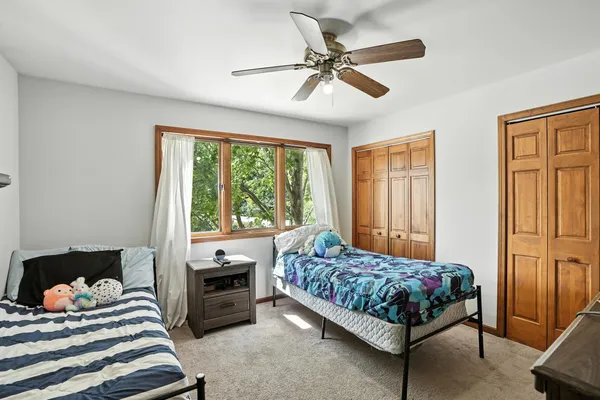 a bedroom with a bed and a window