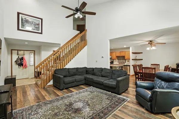 a living room with furniture and wooden floor