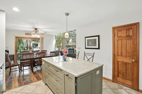 a kitchen with a table chairs and refrigerator