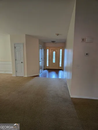 a view of a room with wooden floor and windows