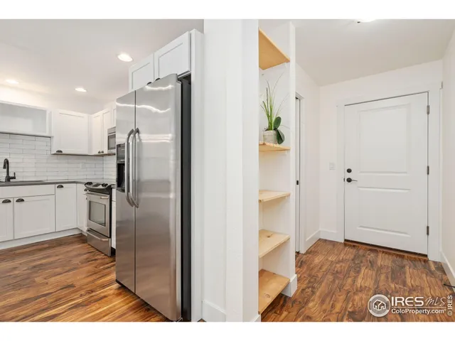 a kitchen with stainless steel appliances a refrigerator sink and cabinets
