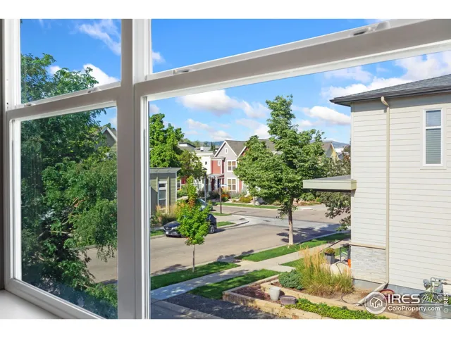 a view of a porch with chairs and potted plants