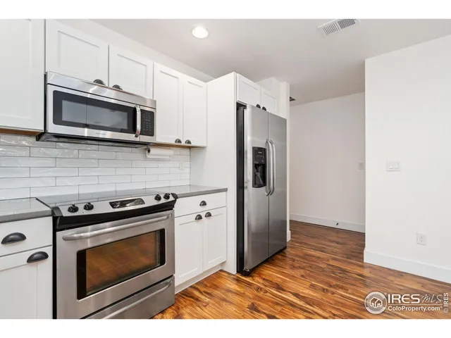 a kitchen with stainless steel appliances a stove a microwave sink and refrigerator