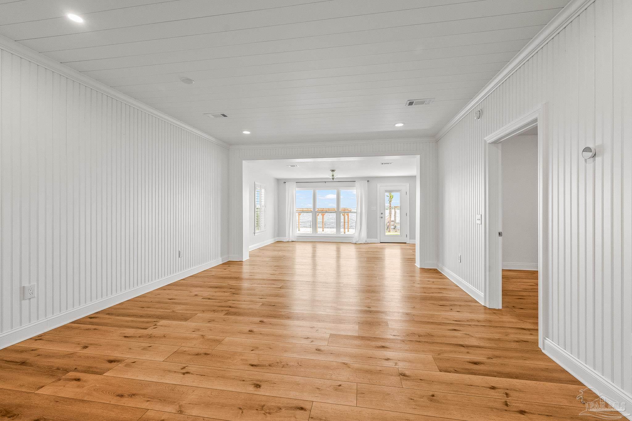 7693 Petersen Point Road Milton, FL 32583 - Photo 11 of 58 a view of empty room with wooden floor and fan