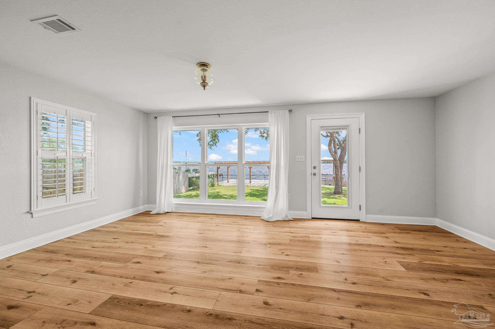 7693 Petersen Point Road Milton, FL 32583 - Photo 15 of 58 a view of an empty room with a window