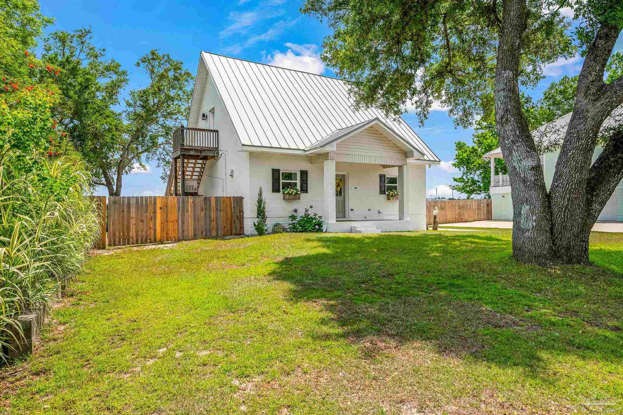 7693 Petersen Point Road Milton, FL 32583 - Photo 2 of 58 a front view of house with yard and trees