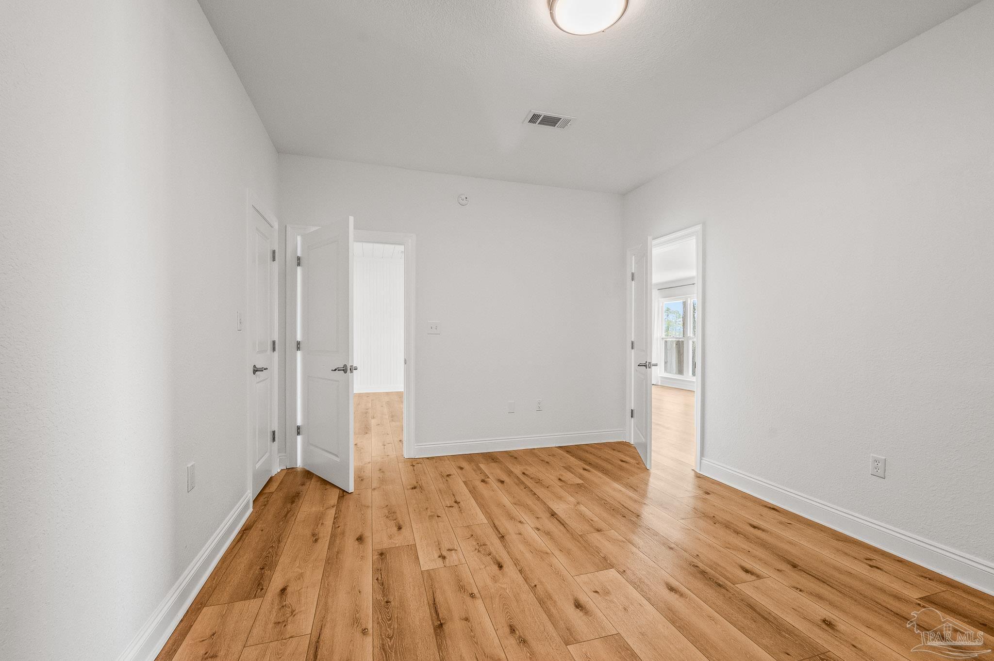 7693 Petersen Point Road Milton, FL 32583 - Photo 25 of 58 a view of room with wooden floor