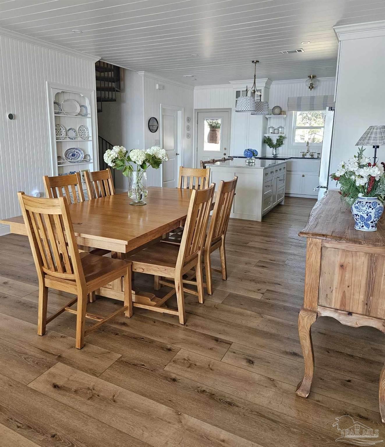 7693 Petersen Point Road Milton, FL 32583 - Photo 35 of 58 a dining room with furniture and wooden floor
