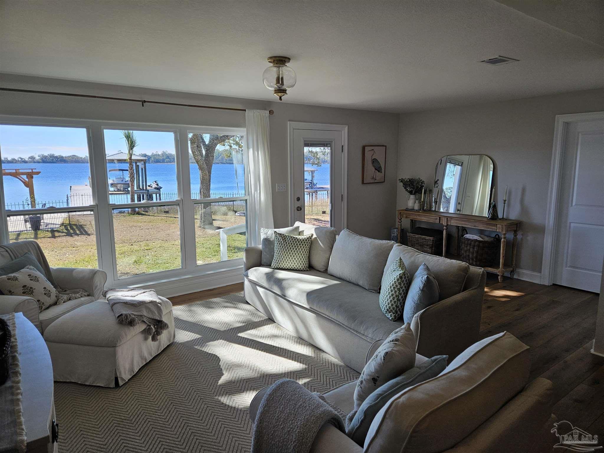 7693 Petersen Point Road Milton, FL 32583 - Photo 35 of 58 a living room with furniture and a large window