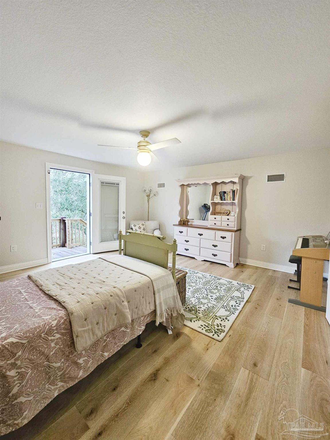 7693 Petersen Point Road Milton, FL 32583 - Photo 39 of 58 a bed room with a bed and a cabinets