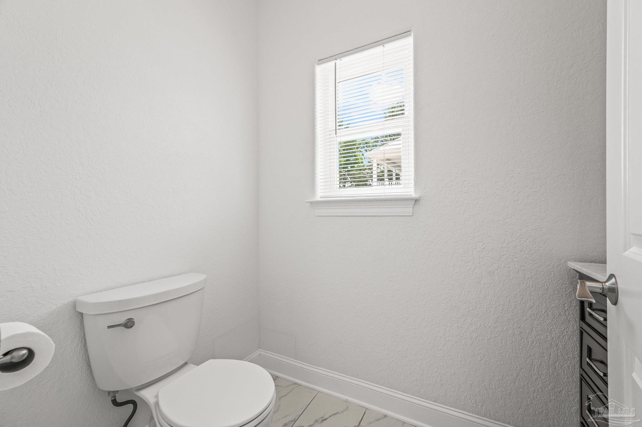 7693 Petersen Point Road Milton, FL 32583 - Photo 44 of 58 a white toilet sitting next to a window