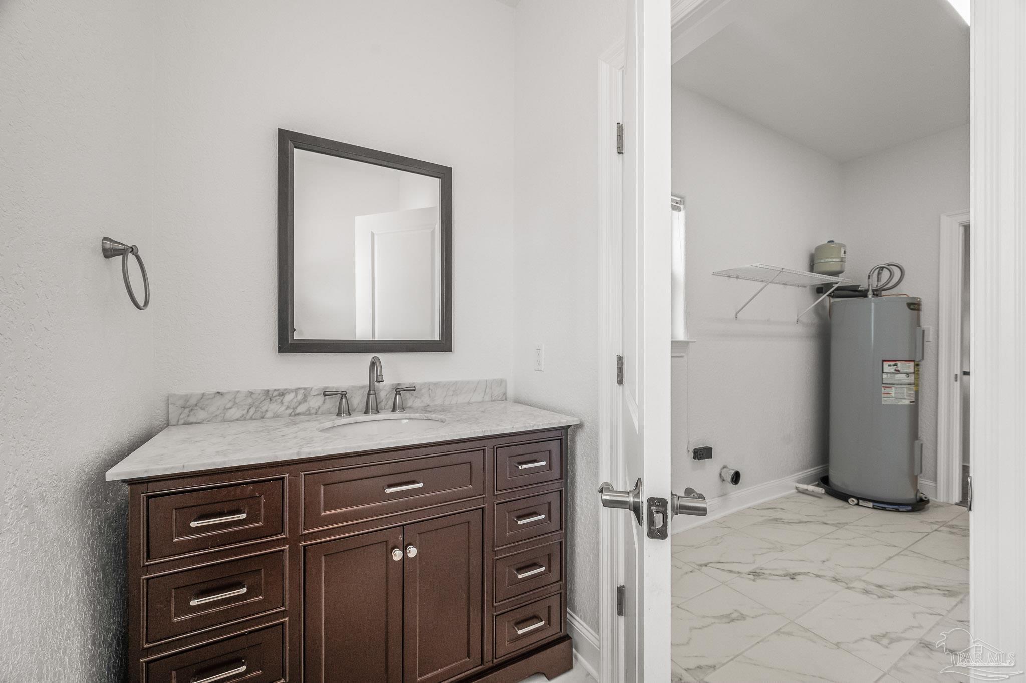 7693 Petersen Point Road Milton, FL 32583 - Photo 45 of 58 a bathroom with a granite countertop sink and a mirror