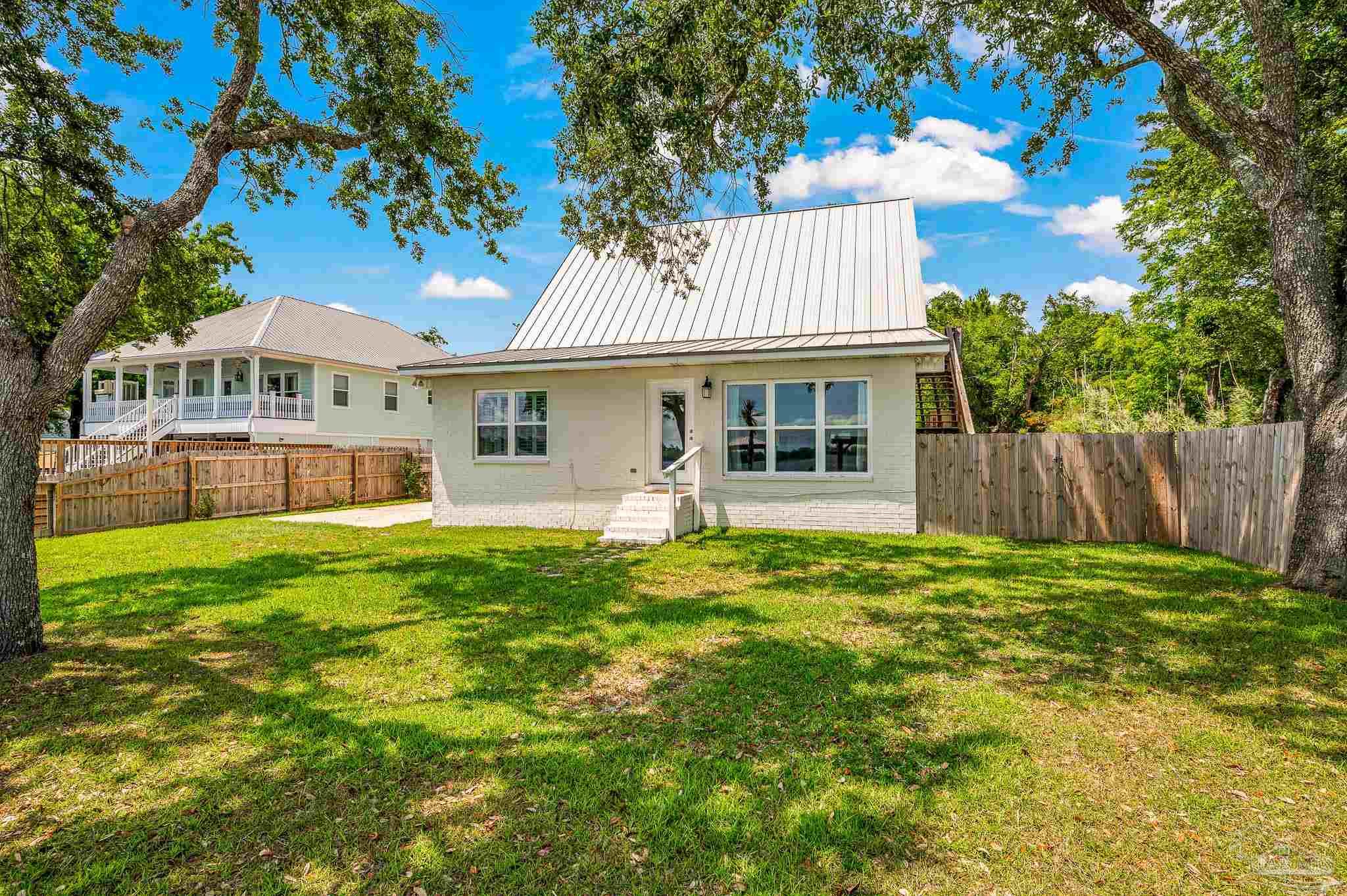 7693 Petersen Point Road Milton, FL 32583 - Photo 48 of 58 a front view of a house with a garden