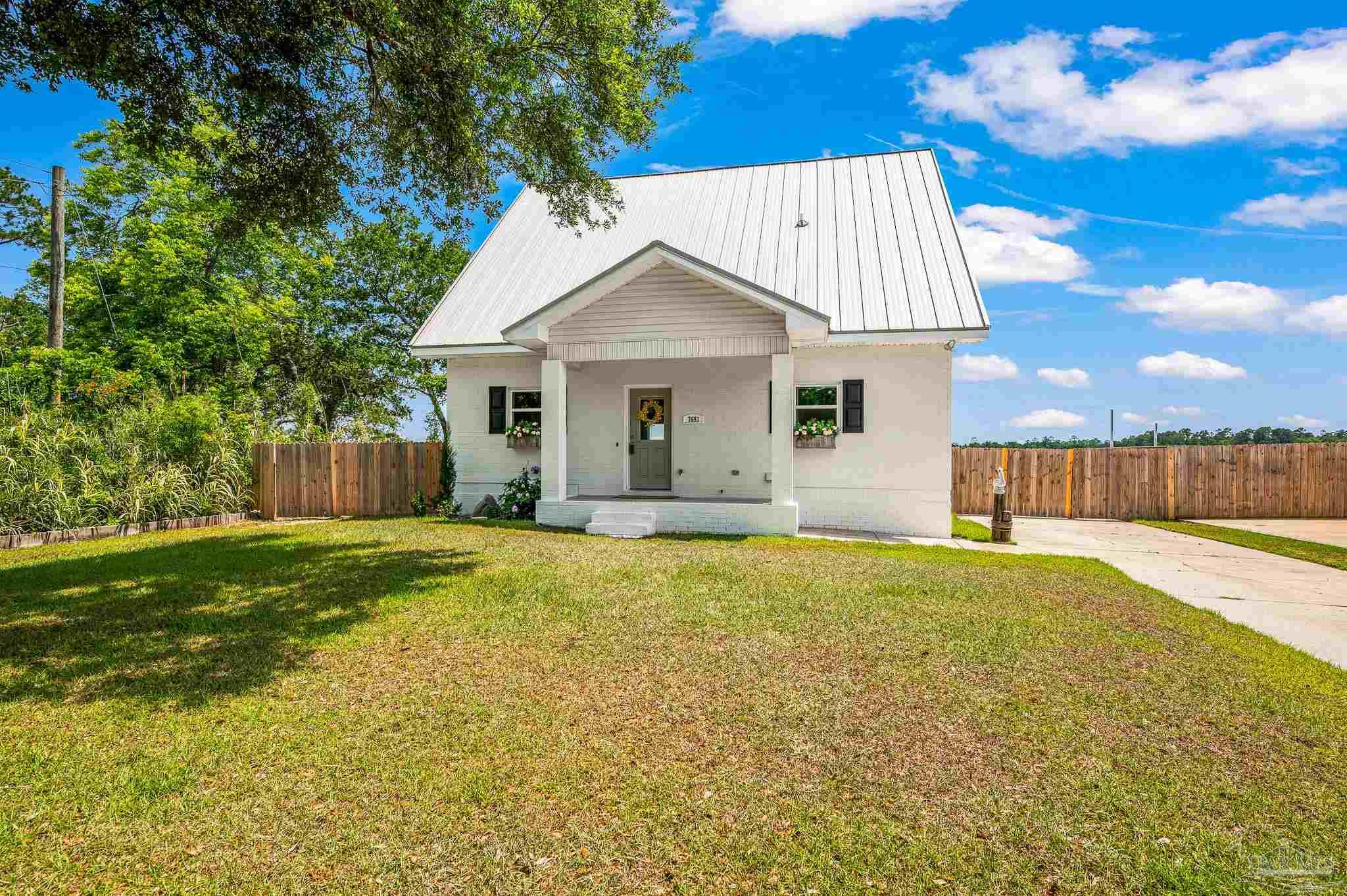 7693 Petersen Point Road Milton, FL 32583 - Photo 58 of 58 a view of a house with backyard and a tree