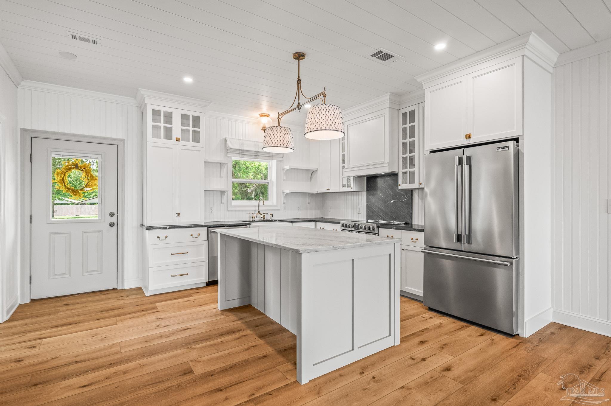 7693 Petersen Point Road Milton, FL 32583 - Photo 10 of 58 a kitchen with stainless steel appliances granite countertop a refrigerator and a stove top oven