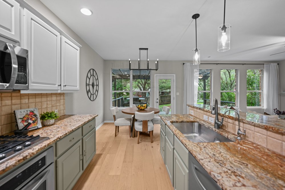 2823 Lantana Ridge Drive Austin, TX 78732 - Photo 12 of 34 a kitchen with granite countertop lots of counter top space