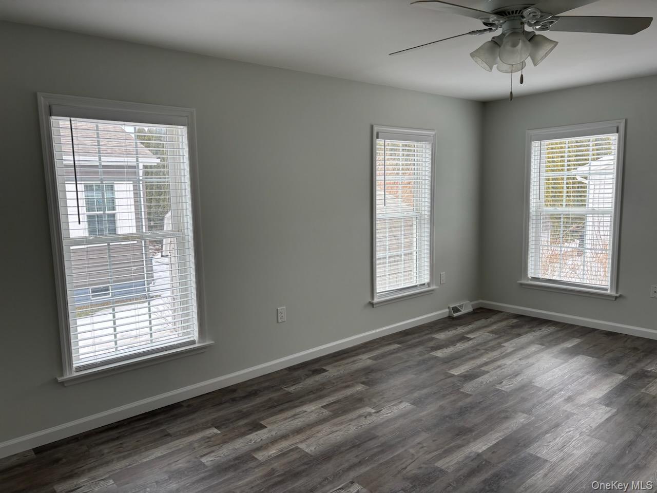 1661 Old Country Road, Unit 539 Riverhead, NY 11901 - Photo 14 of 26 a view of an empty room with a window and wooden floor