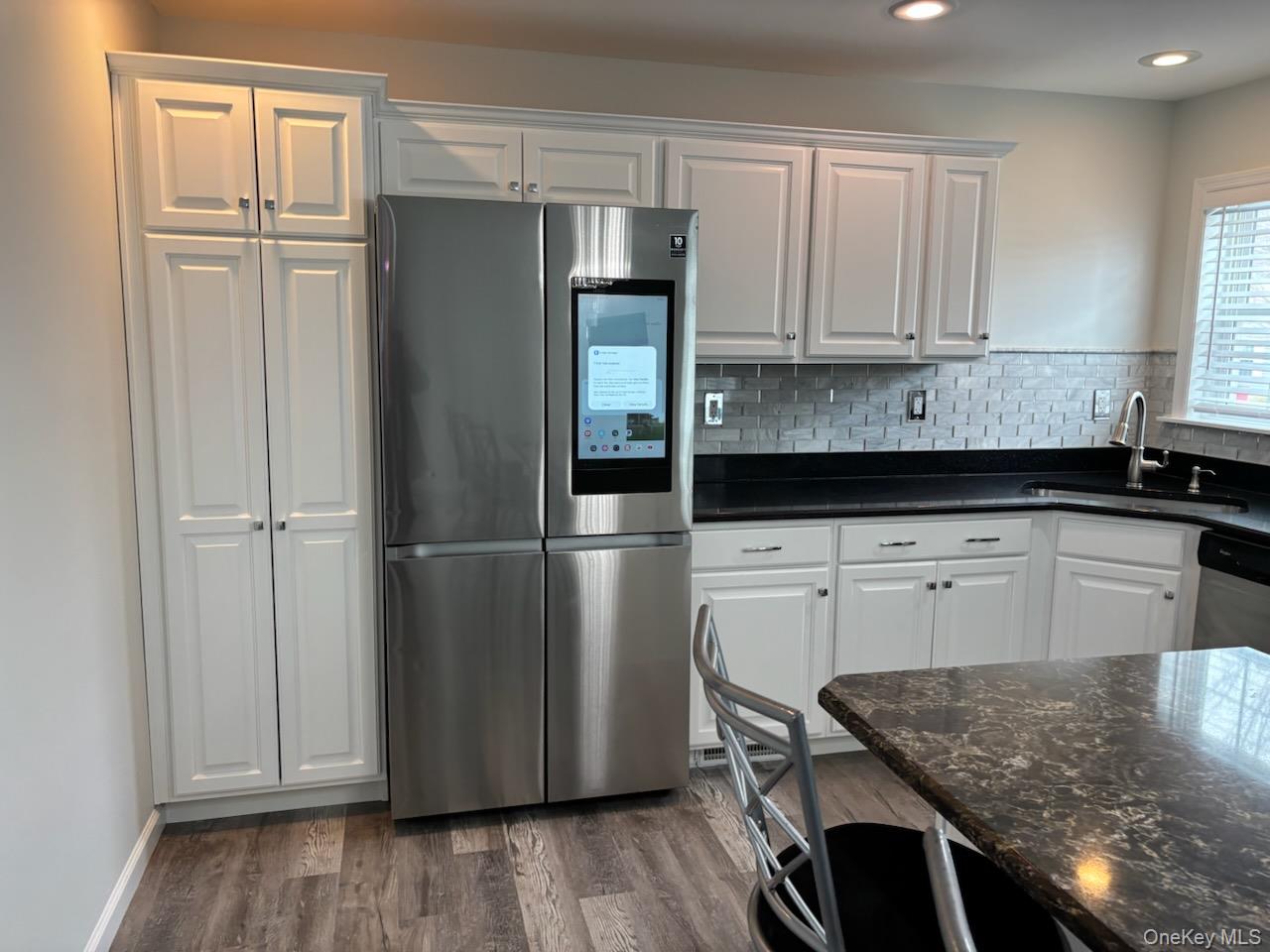 1661 Old Country Road, Unit 539 Riverhead, NY 11901 - Photo 18 of 26 a kitchen with a refrigerator and cabinets