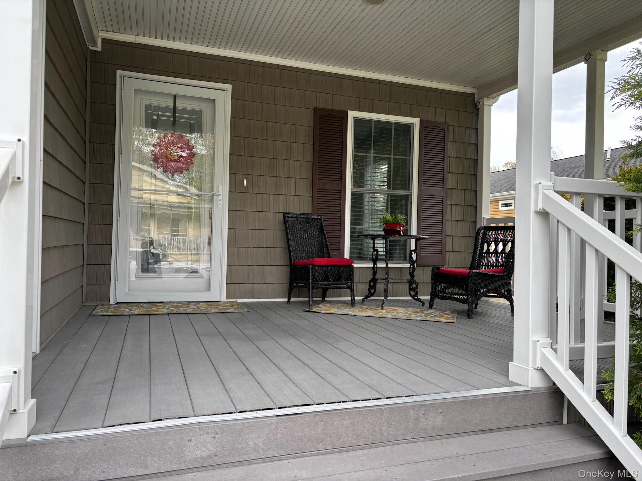 1661 Old Country Road, Unit 539 Riverhead, NY 11901 - Photo 3 of 26 wooden floor on a city street with a bench