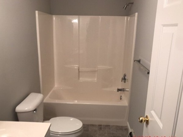 10 Central Tree Road, Unit 10 Rutland, MA 01543 - Photo 17 of 25 a white toilet and tub sitting next to a shower