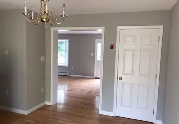 10 Central Tree Road, Unit 10 Rutland, MA 01543 - Photo 8 of 25 a view of a chandelier in hallway with wooden floor