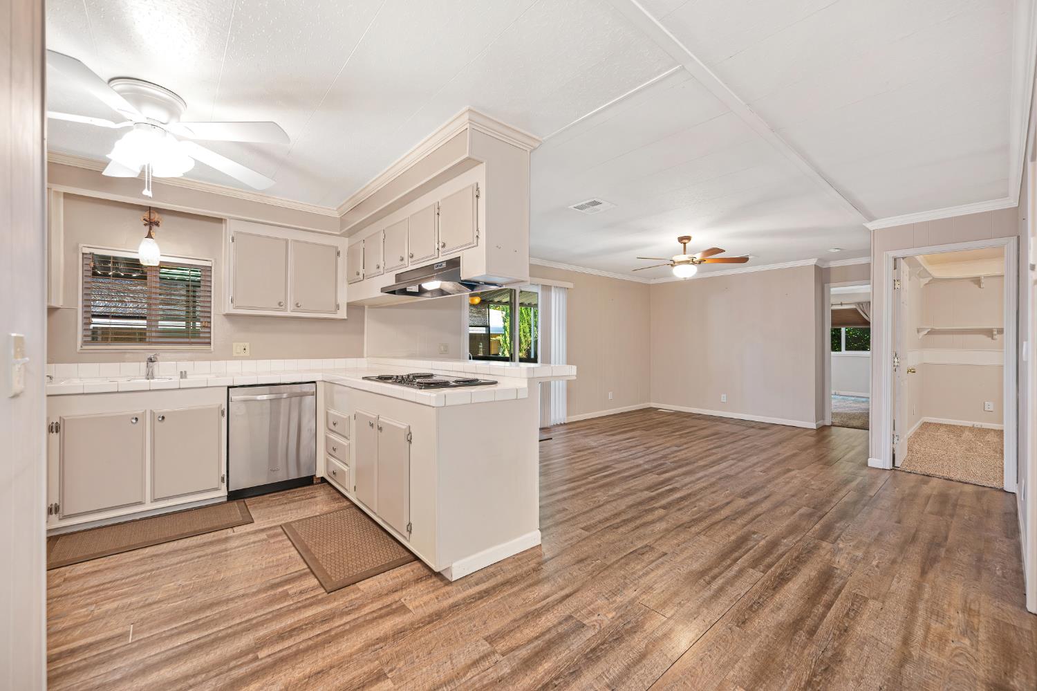 4237 Pinewood Street Rocklin, CA 95677 - Photo 16 of 54 a kitchen with a sink cabinets stainless steel appliances and wooden floor