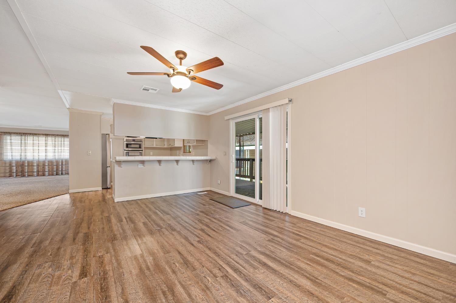 4237 Pinewood Street Rocklin, CA 95677 - Photo 17 of 54 a view of a kitchen with wooden floor and a ceiling fan