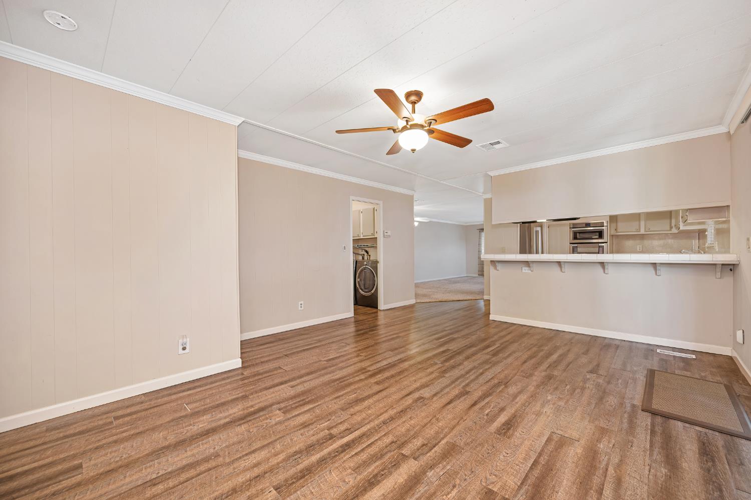 4237 Pinewood Street Rocklin, CA 95677 - Photo 20 of 54 a view of a kitchen with wooden floor and a ceiling fan