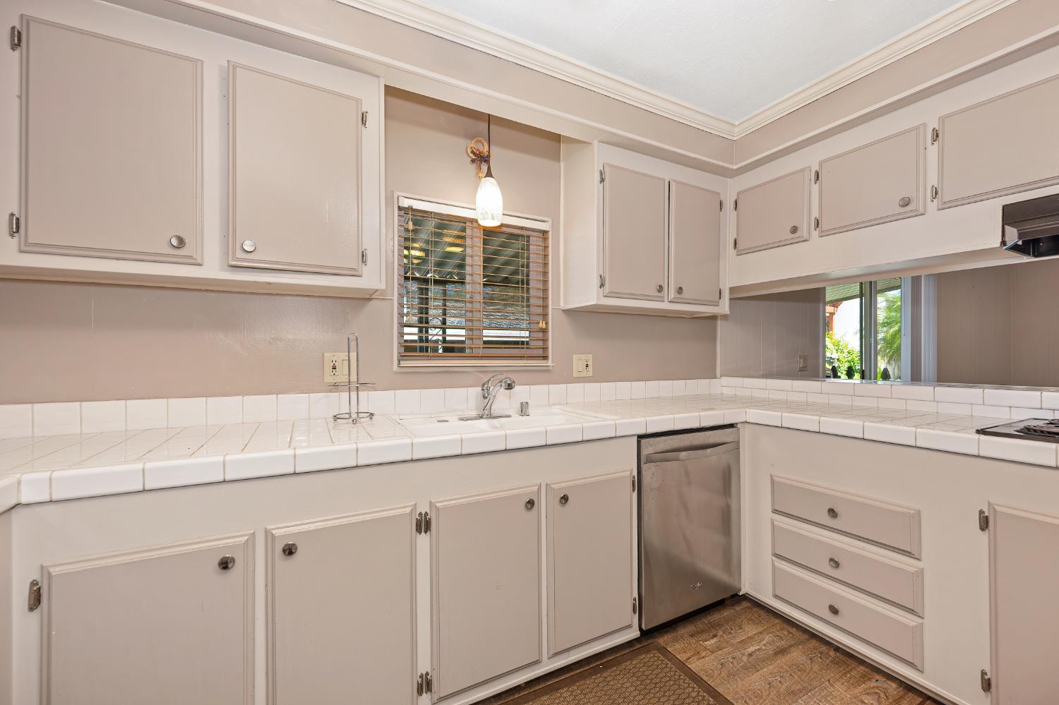 4237 Pinewood Street Rocklin, CA 95677 - Photo 25 of 54 a kitchen with white cabinets and a window