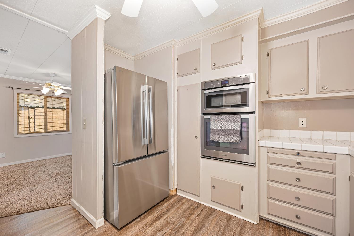 4237 Pinewood Street Rocklin, CA 95677 - Photo 26 of 54 a kitchen with stainless steel appliances white cabinets and wooden floors