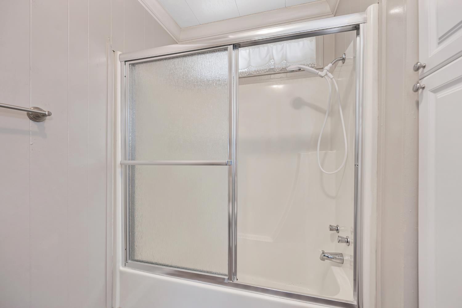 4237 Pinewood Street Rocklin, CA 95677 - Photo 29 of 54 a bathroom with a glass shower door