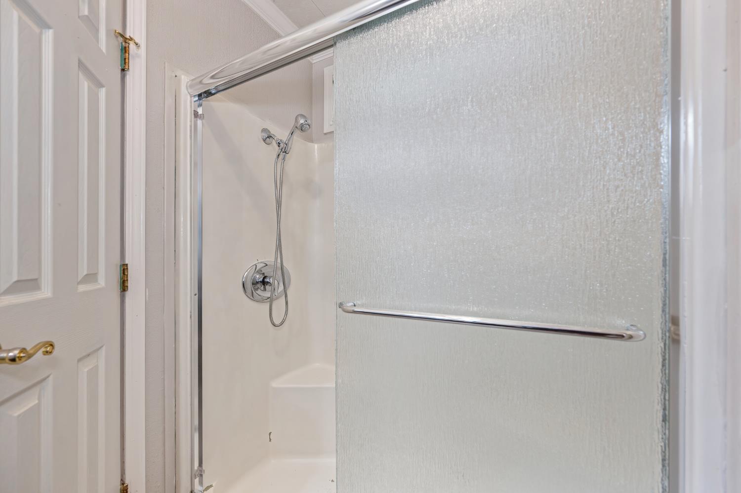 4237 Pinewood Street Rocklin, CA 95677 - Photo 30 of 54 a bathroom with a glass shower door