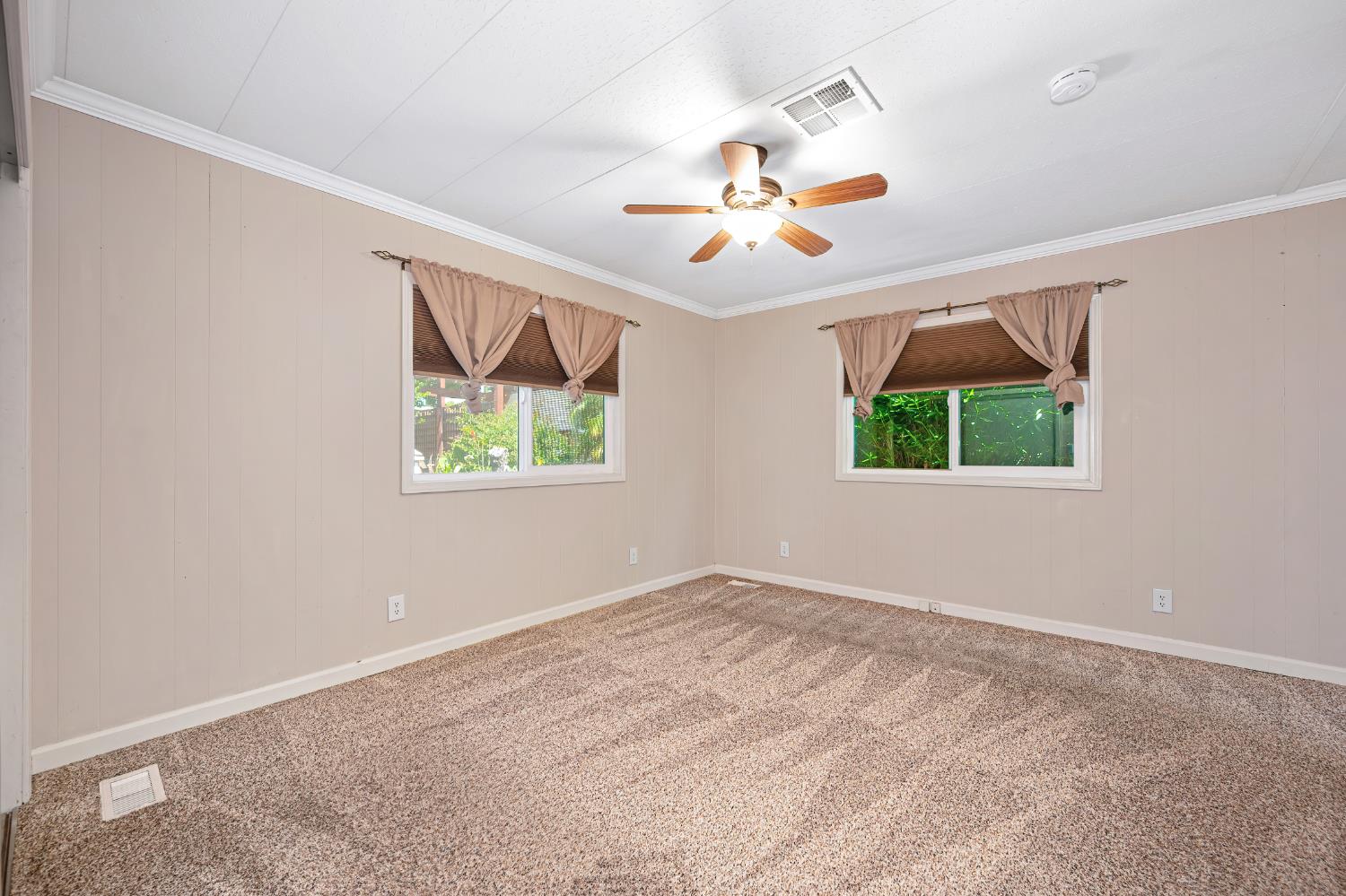 4237 Pinewood Street Rocklin, CA 95677 - Photo 33 of 54 an empty room with windows and a ceiling fan