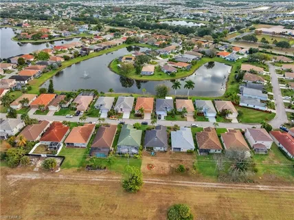 an aerial view of residential houses with outdoor space and lake view